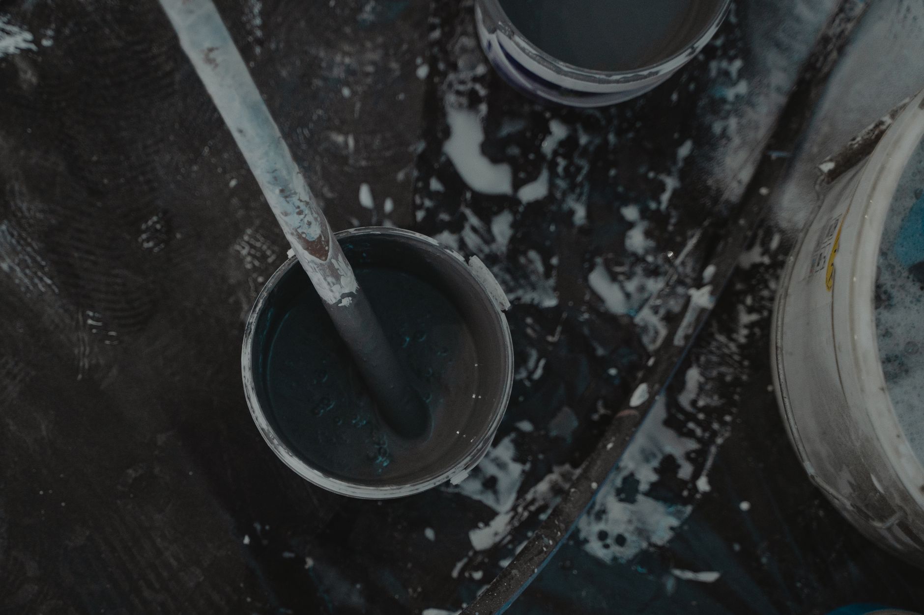 Aerial shot of paint buckets and tools on a construction site, showcasing a renovation project in Temecula, CA