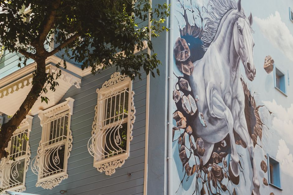 Blue painted house wall with decorative window trim
