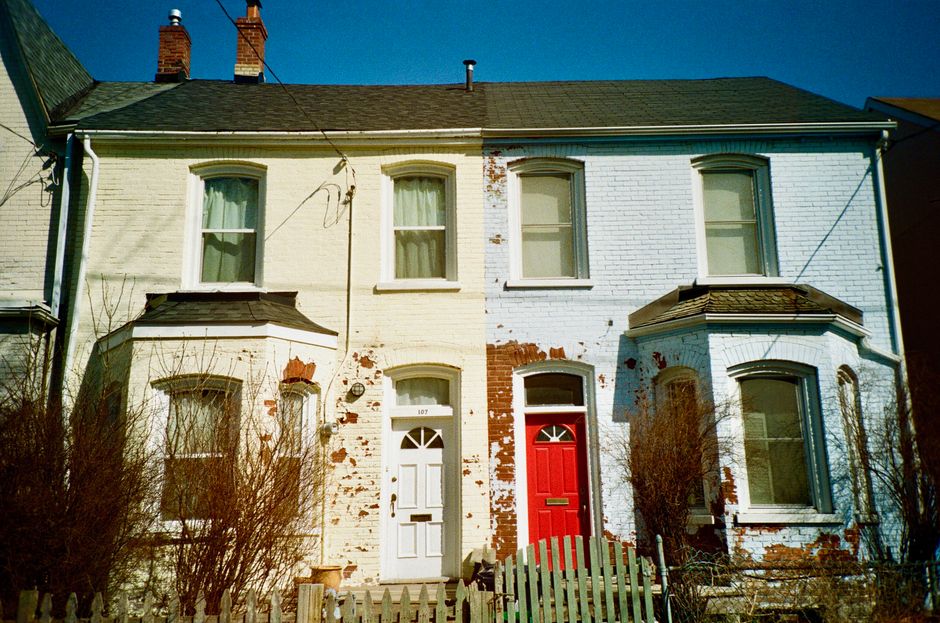 Brick house fronts with painted red and white doors