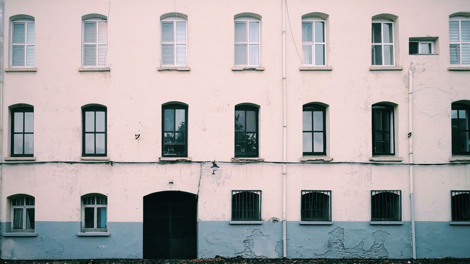 Painted house front with evenly spaced windows